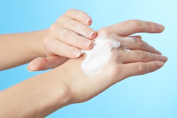 Woman's hands in moisturizer cream