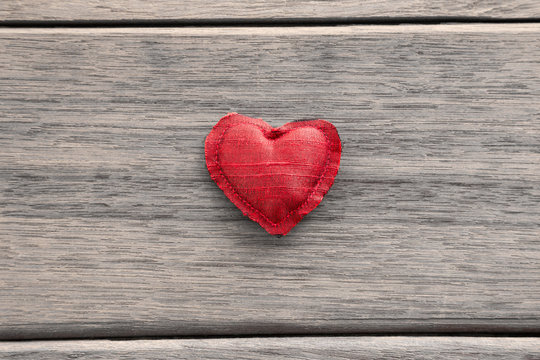 Red valentine heart symbol on wood background