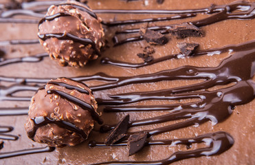 Chocolate balls toppings on chocolate cheese cake close up view