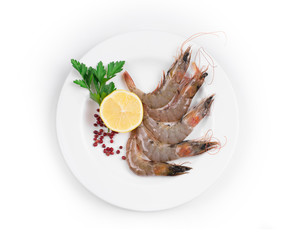 Raw shrimps on white plate.
