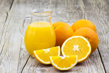 Obraz na płótnie Canvas orange juice and fresh fruits on wooden background