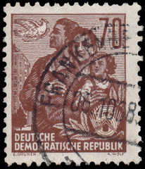 Stamp printed in GDR, shows a family