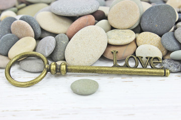 Antique Key to Love on a beach stone background