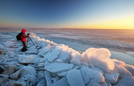 Photographer Take Pictures On The River Bank In Winter