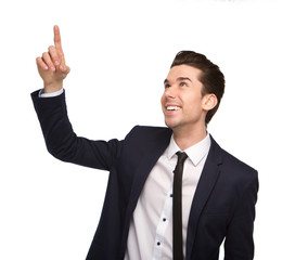 Smiling young business man pointing finger