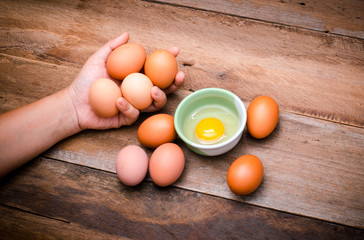 eggs in hand put on wooden