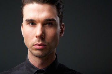 Fototapeta premium Handsome young man posing against gray background