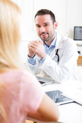 Young attractive doctor listening his patient