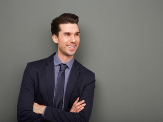 Smiling business man standing with arms crossed