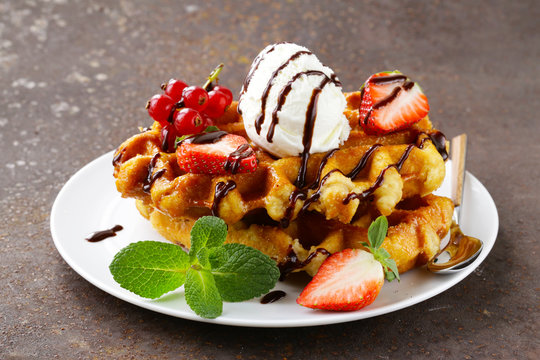 Belgian waffles with berries and ice cream