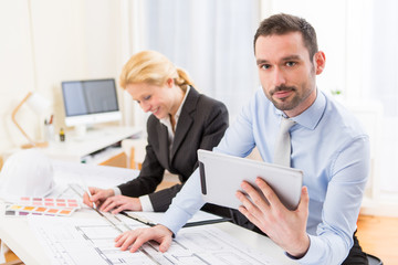 Young attractive engineer working at the office