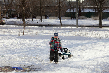 Fototapeta na wymiar Child with a snow racer