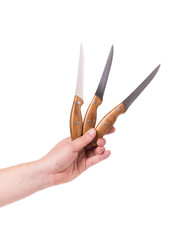 Hand holds three knifes.