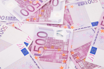Euro notes aligned as background.