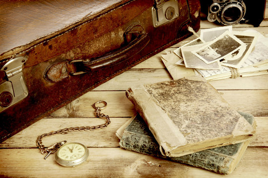 old suitcase, books, photos in retro style