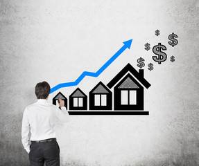 businessman drawing chart and house
