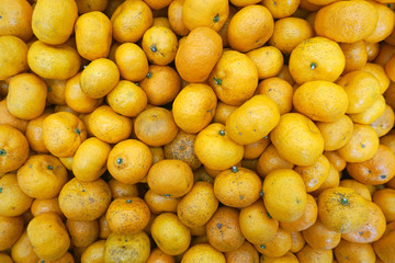 Tangerines as the background. Big bunch of ripe tangerines.