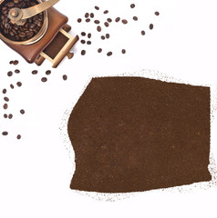 Coffee powder in the shape of Equatorial Guinea and a coffee mil