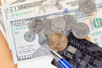 US coins and banknotes with credit card and pen