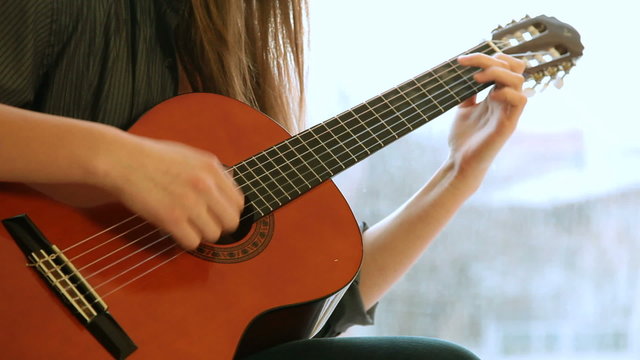 Teenager Girl Playing Guitar