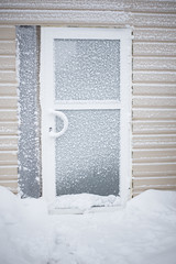 Aluminium glass door covered with snow