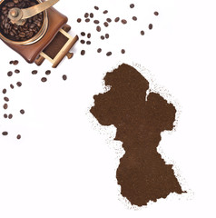 Coffee powder in the shape of Guyana and a coffee mill.(series)