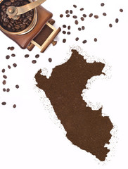 Coffee powder in the shape of Peru and a coffee mill.(series)