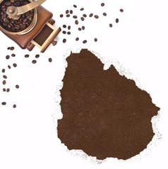 Coffee powder in the shape of Uruguay and a coffee mill.(series)