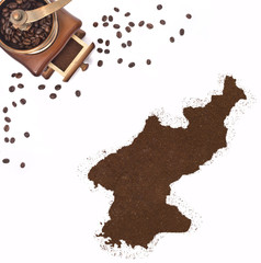 Coffee powder in the shape of North Korea and a coffee mill.(ser