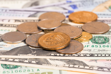 US coins on US banknotes close up