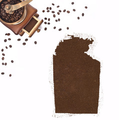 Coffee powder in the shape of Northern Territory and a coffee mi