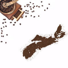 Coffee powder in the shape of Nova Scotia and a coffee mill.(ser