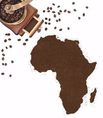 Coffee powder in the shape of Africa and a coffee mill.(series)