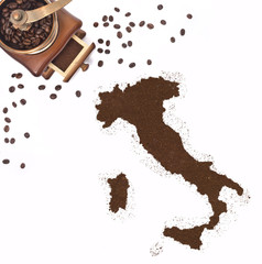 Coffee powder in the shape of Italy and a coffee mill.(series)