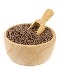A bowl of chocolate sprinkles with scoop on white background