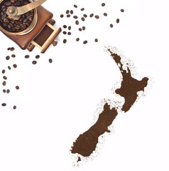 Coffee powder in the shape of New Zealand and a coffee mill.(ser