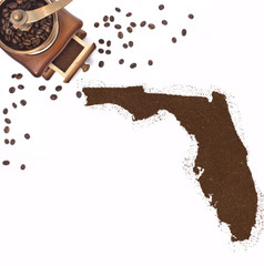 Coffee powder in the shape of Florida and a coffee mill.(series)