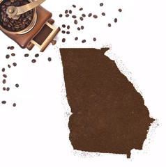 Coffee powder in the shape of Georgia and a coffee mill.(series)