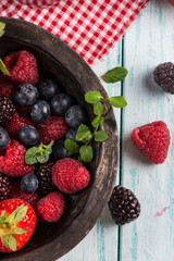 Rustic bowl with fresh summer berries fruits