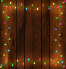 Garland frame on wood background