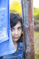 Portrait of a young girl with expressive eyes in the village.