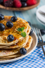 Homemade golden pancake with fresh berrys and mint