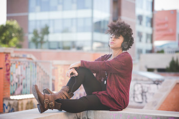 beautiful black curly hair african woman listening music with he