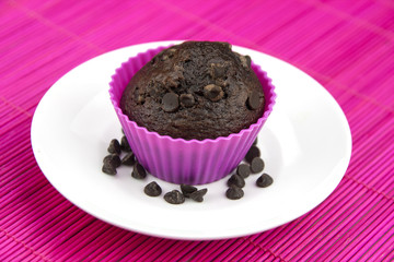 Close up of chocolate muffins on a wooden and pink placemat