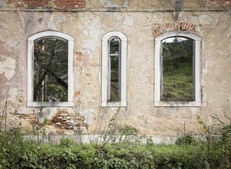 Fototapeta na wymiar old broken windows on a rural house in ruins