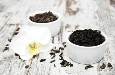 Fototapeta na wymiar Black and green tea with orchid flower