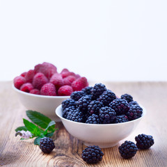 Bowls overflowing with summer berries 