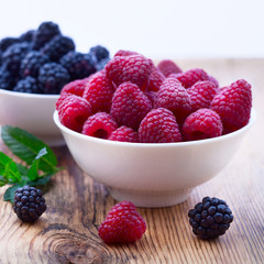 Bowls overflowing with summer berries 