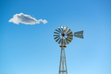 Old Style Windmill Against a Blue Sky
