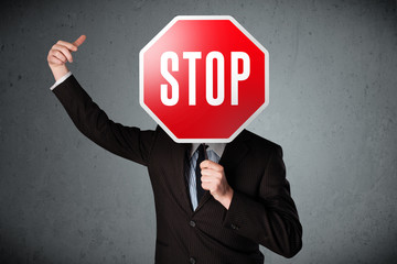 Businessman holding a stop sign